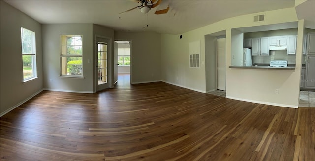 413 Summit Ridge Pl Unit 115, Longwood, FL 32779 - unfurnished living room with dark wood-style flooring and ceiling fan