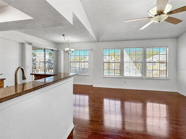 unfurnished living room with dark wood-style floors and a textured ceiling