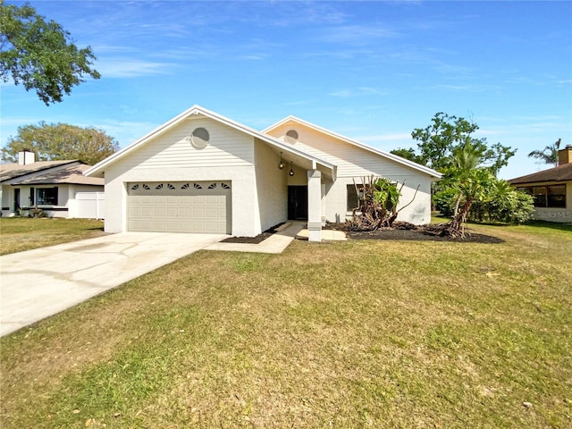 mid-century home with a front lawn, concrete driveway, and an attached garage