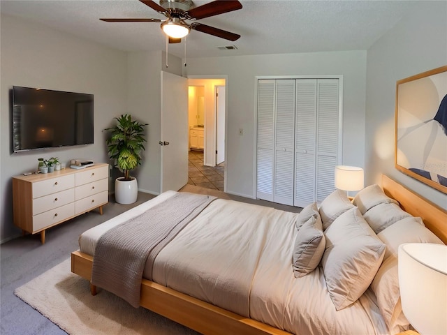 bedroom featuring visible vents, a ceiling fan, a closet, carpet flooring, and baseboards