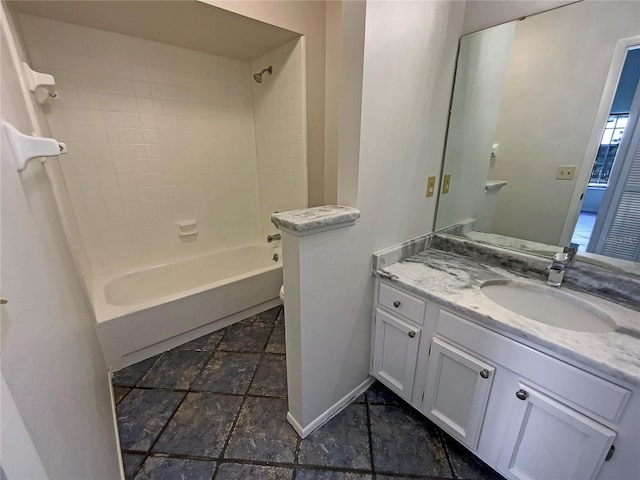 full bath featuring baseboards, toilet, shower / tub combination, stone tile floors, and vanity