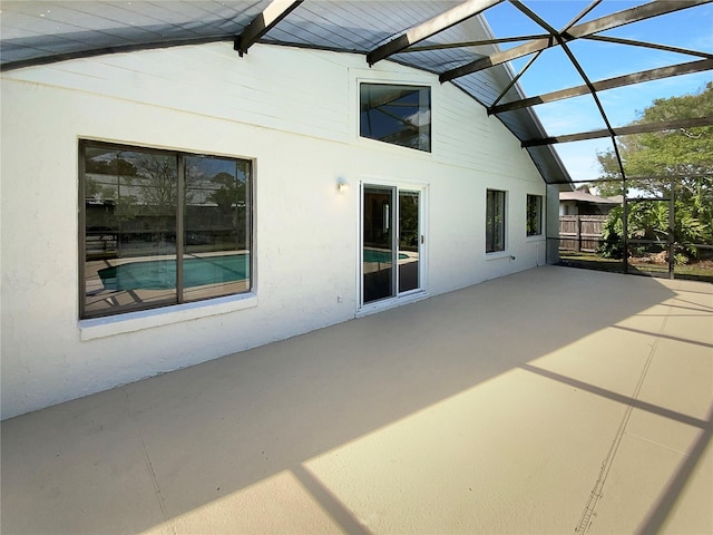 view of patio featuring a lanai