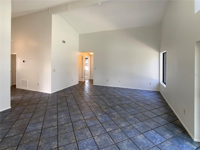 empty room with visible vents, high vaulted ceiling, and baseboards