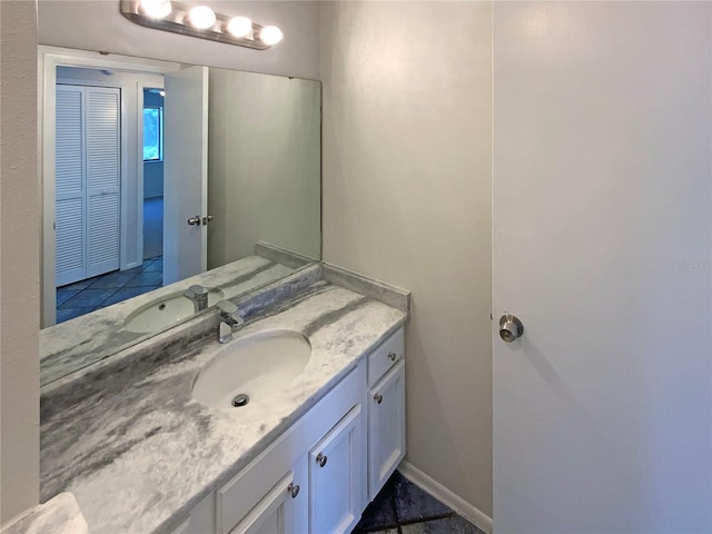 bathroom featuring vanity and baseboards