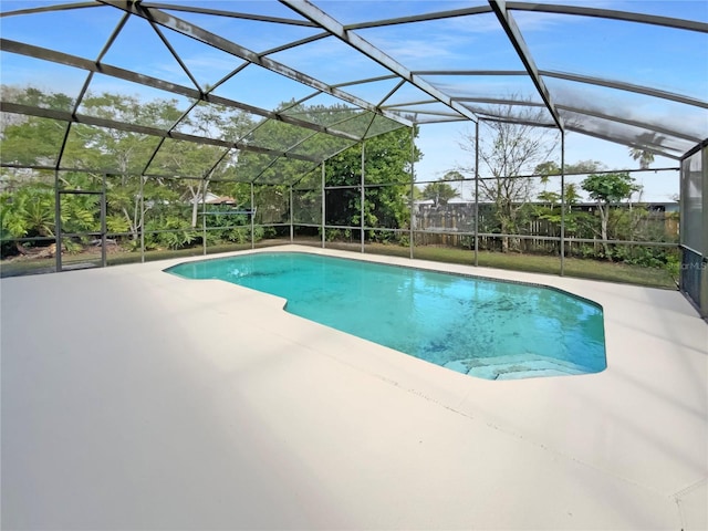 pool with a lanai and a patio area