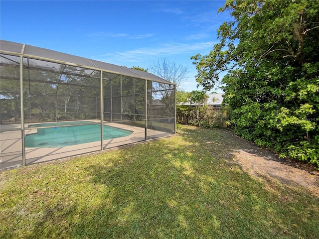 outdoor pool featuring a lanai, a lawn, and fence