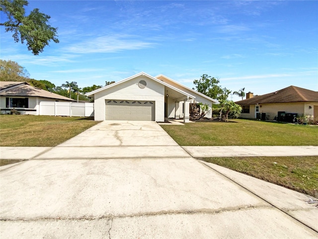 view of front of property with driveway, an attached garage, a front yard, and fence