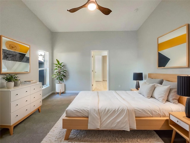 carpeted bedroom featuring baseboards, lofted ceiling, and a ceiling fan