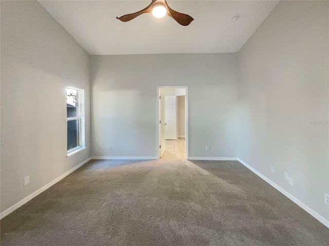 spare room featuring a ceiling fan, carpet, and baseboards