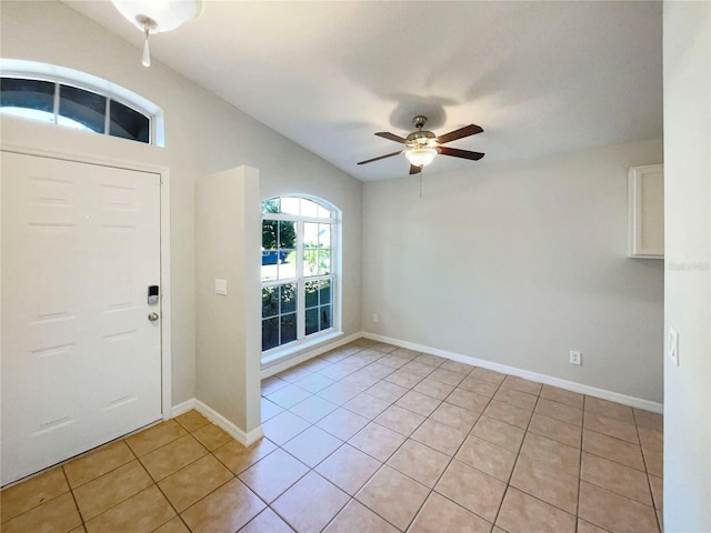 foyer with light tile patterned floors, baseboards, and ceiling fan