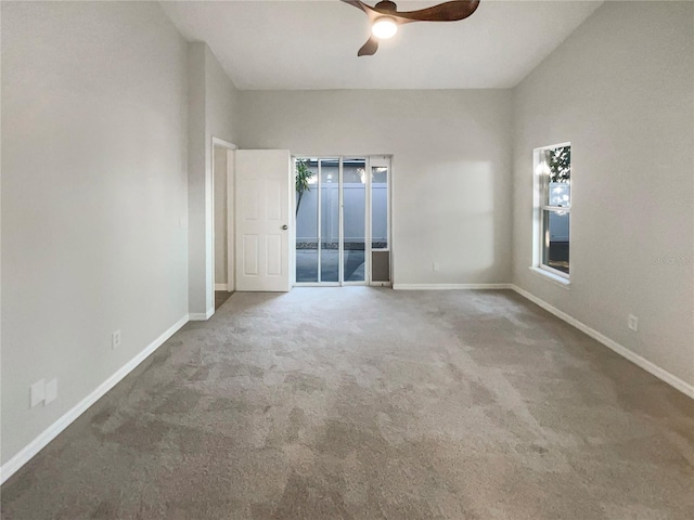 empty room with a ceiling fan, baseboards, and carpet floors