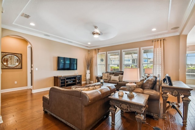 living area with baseboards, recessed lighting, arched walkways, wood-type flooring, and crown molding