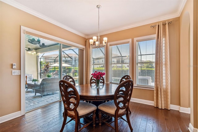 dining area with dark wood-style floors, a chandelier, and plenty of natural light