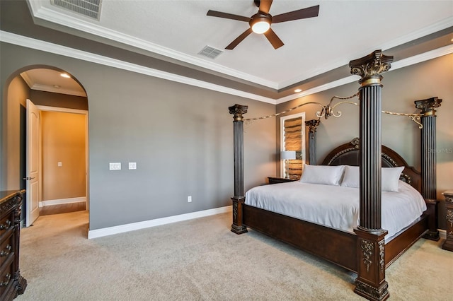 carpeted bedroom featuring ornamental molding, arched walkways, visible vents, and baseboards