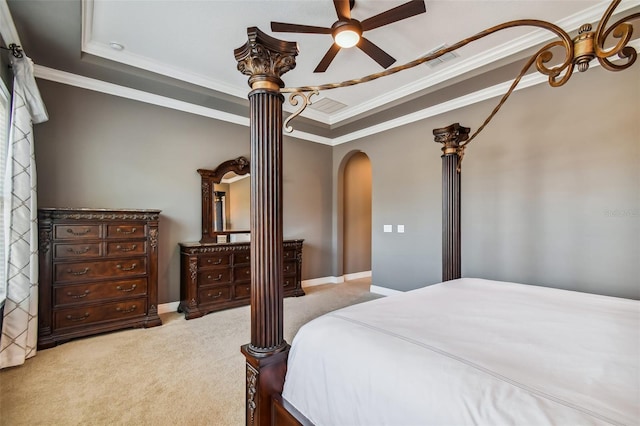 bedroom featuring arched walkways, visible vents, carpet flooring, and a tray ceiling