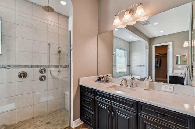 full bath with vanity, a shower stall, a spacious closet, and visible vents