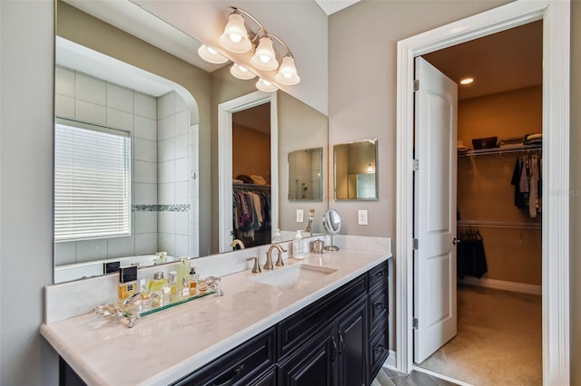 full bathroom featuring baseboards and vanity