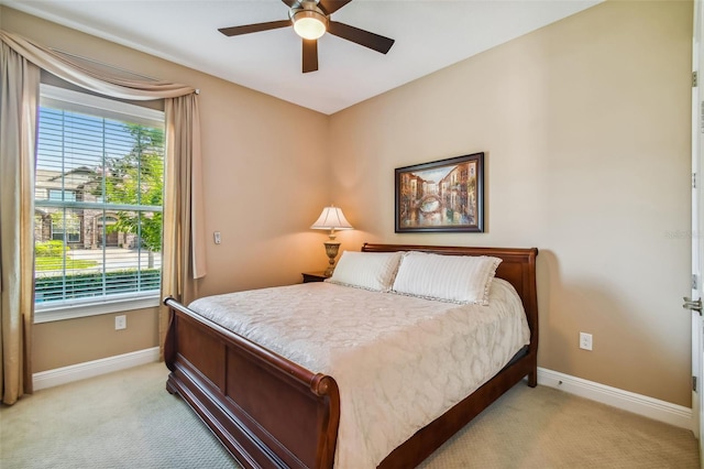 bedroom with baseboards, light carpet, and ceiling fan