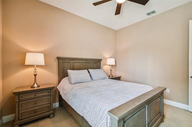 bedroom with visible vents, light colored carpet, a ceiling fan, and baseboards