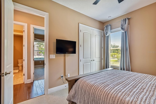 bedroom with a closet, baseboards, and ceiling fan