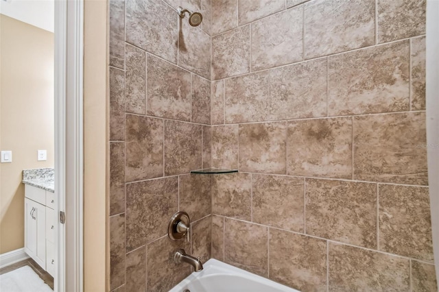 details with vanity and shower / tub combination