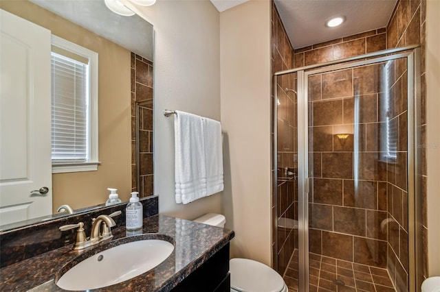 full bathroom with a stall shower, toilet, and vanity