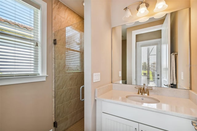 bathroom featuring vanity and a shower stall