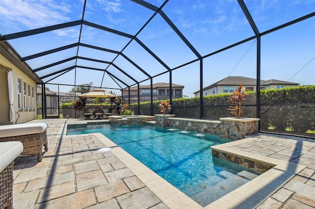 view of swimming pool with glass enclosure, a patio, and a pool with connected hot tub