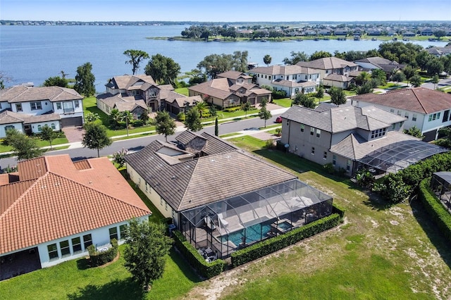 drone / aerial view featuring a residential view and a water view