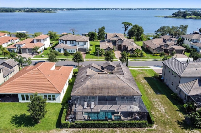 drone / aerial view featuring a residential view and a water view