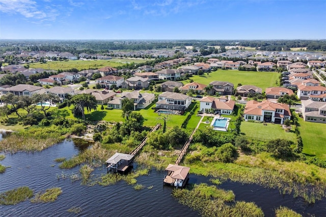 drone / aerial view with a residential view and a water view