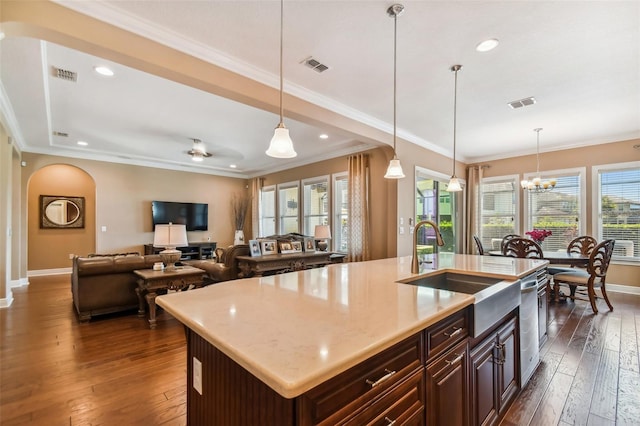 16736 Broadwater Ave, Winter Garden, FL 34787 - kitchen with arched walkways, stainless steel dishwasher, dark wood-style flooring, crown molding, and pendant lighting
