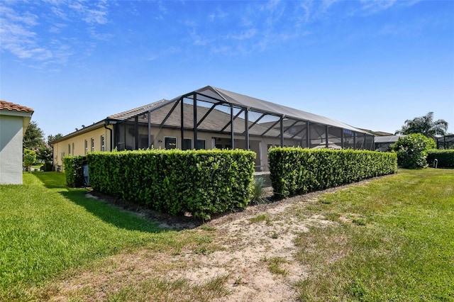 16736 Broadwater Ave, Winter Garden, FL 34787 - rear view of property with a lawn, stucco siding, and a lanai