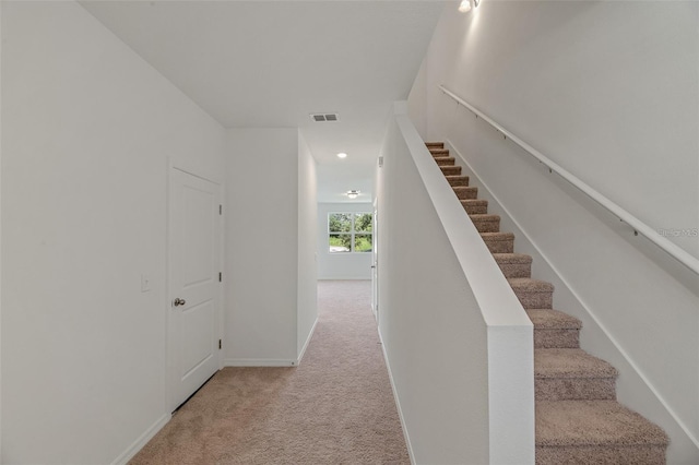 stairway featuring visible vents, recessed lighting, baseboards, and carpet floors