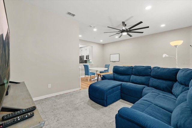 living room with visible vents, baseboards, ceiling fan, recessed lighting, and wood finished floors