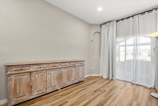 empty room featuring baseboards and light wood-style floors