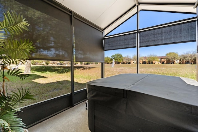 sunroom with plenty of natural light and vaulted ceiling