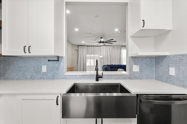 kitchen featuring a sink, white cabinetry, stainless steel dishwasher, and light countertops