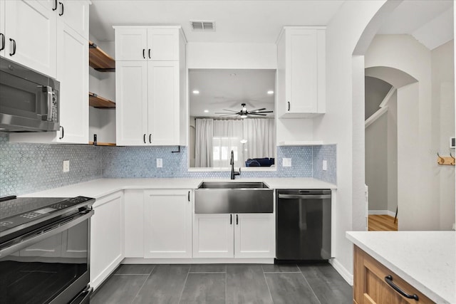 kitchen featuring visible vents, black electric range oven, open shelves, a sink, and stainless steel dishwasher