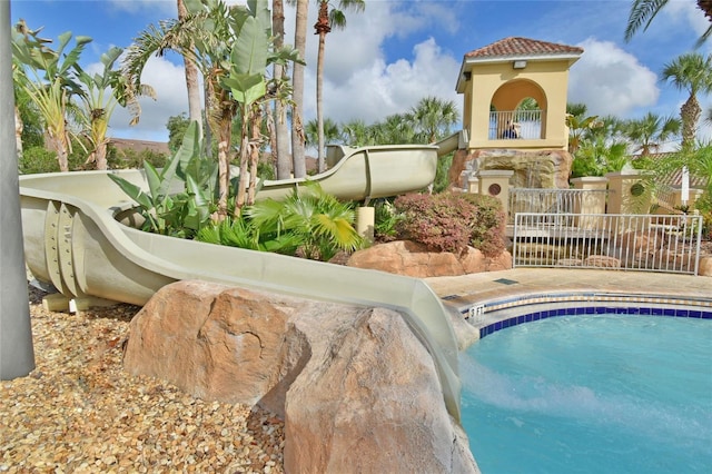 view of swimming pool featuring fence and a fenced in pool