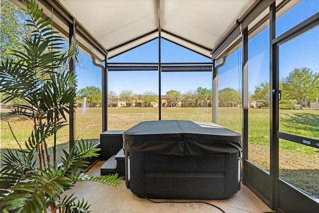 sunroom with a jacuzzi and a healthy amount of sunlight