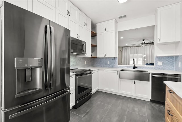kitchen featuring electric stove, dishwashing machine, stainless steel fridge with ice dispenser, light countertops, and visible vents