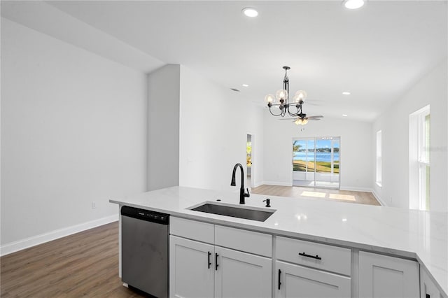 kitchen with a notable chandelier, a sink, light stone counters, white cabinetry, and dishwasher