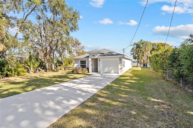view of front facade featuring stucco siding, a front lawn, fence, concrete driveway, and an attached garage