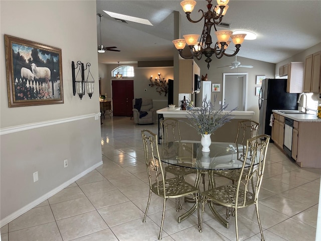 dining area with visible vents, baseboards, vaulted ceiling, ceiling fan with notable chandelier, and light tile patterned flooring