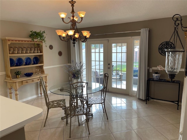 dining space with light tile patterned flooring, a chandelier, french doors, and baseboards