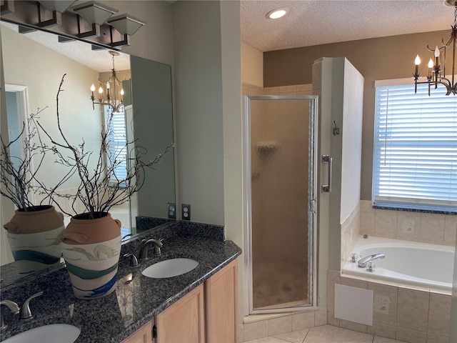 bathroom featuring a chandelier, a textured ceiling, and a sink