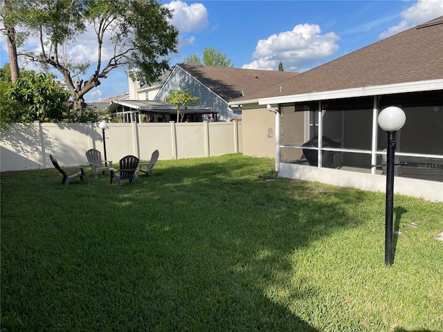 view of yard featuring a sunroom and fence