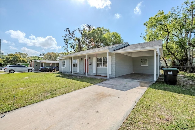 5210 Grandview Dr, Orlando, FL 32808 - ranch-style home with driveway, a front lawn, a porch, a carport, and brick siding