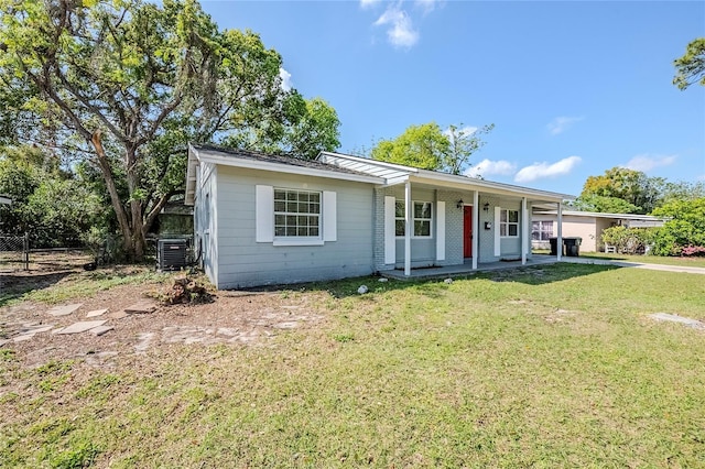 5210 Grandview Dr, Orlando, FL 32808 - ranch-style home with covered porch, a front yard, and central AC